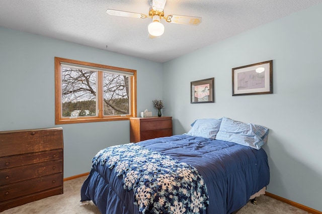 bedroom featuring carpet floors, ceiling fan, a textured ceiling, and baseboards