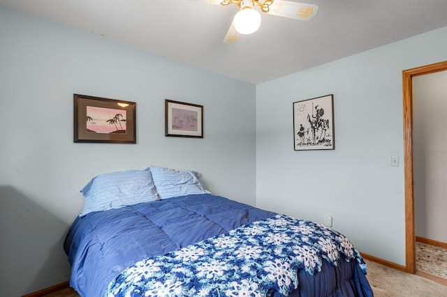 carpeted bedroom featuring ceiling fan and baseboards