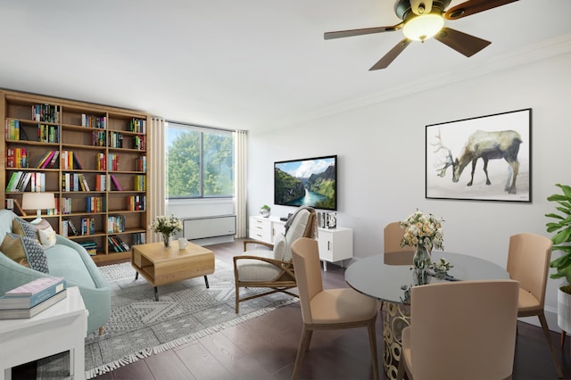 living area with dark hardwood / wood-style flooring, ornamental molding, and ceiling fan