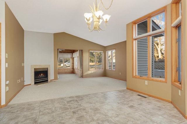 unfurnished living room featuring visible vents, a fireplace with flush hearth, carpet, vaulted ceiling, and a chandelier