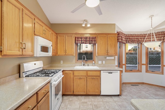 kitchen with light countertops, white appliances, a sink, and a ceiling fan