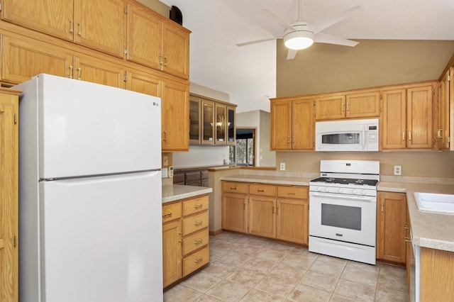 kitchen with light tile patterned floors, white appliances, ceiling fan, vaulted ceiling, and light countertops