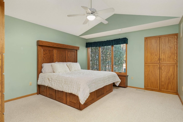 bedroom with lofted ceiling, light colored carpet, and baseboards