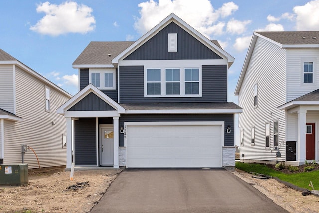 view of front of property featuring a garage and central AC