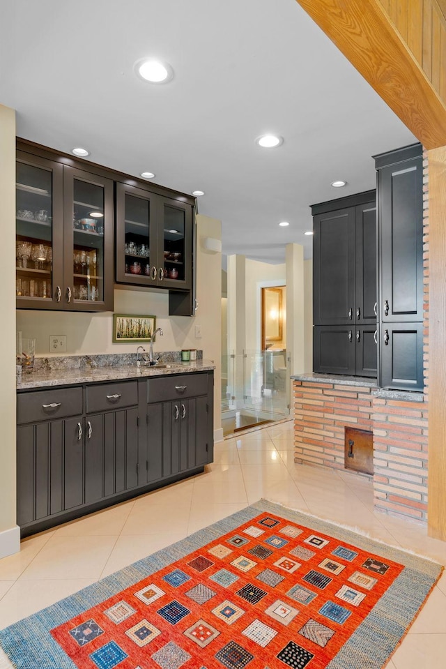 bar with wet bar, light tile patterned flooring, a sink, and recessed lighting