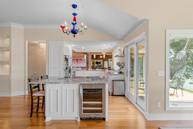 bar featuring light wood finished floors, wine cooler, a notable chandelier, and crown molding