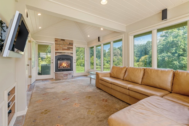 living room with carpet floors, recessed lighting, lofted ceiling with beams, wood ceiling, and a stone fireplace