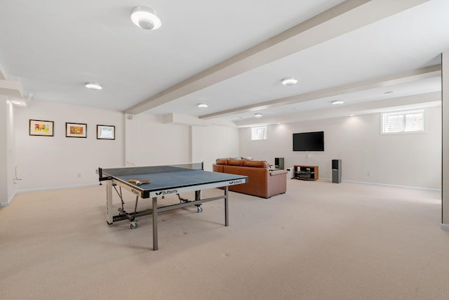 game room featuring light carpet, beam ceiling, and baseboards