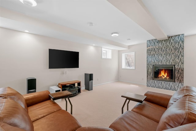 carpeted living area with a fireplace, baseboards, and beamed ceiling