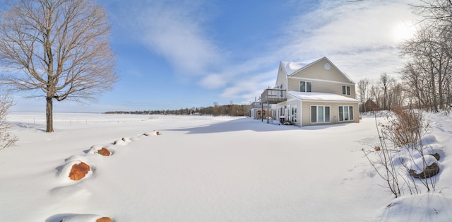 view of snow covered rear of property