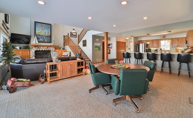 dining area featuring stairs, a fireplace, and recessed lighting