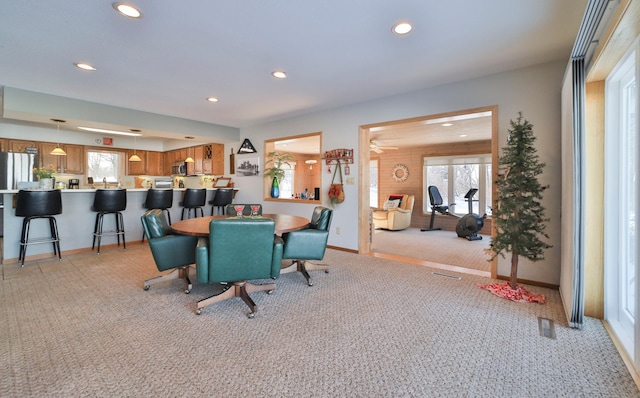 dining area with recessed lighting, baseboards, and light colored carpet