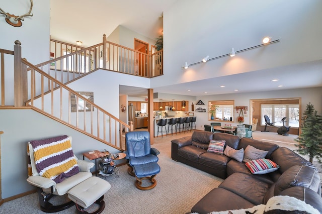 living room featuring carpet, a high ceiling, stairway, and recessed lighting