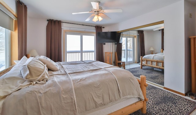 carpeted bedroom featuring access to exterior, ceiling fan, and baseboards