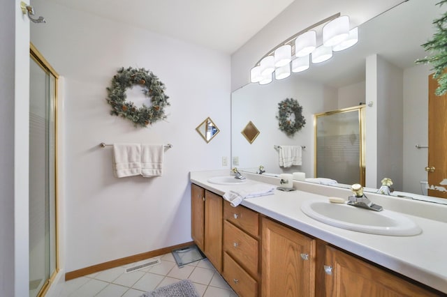 bathroom featuring a stall shower, tile patterned flooring, visible vents, and a sink