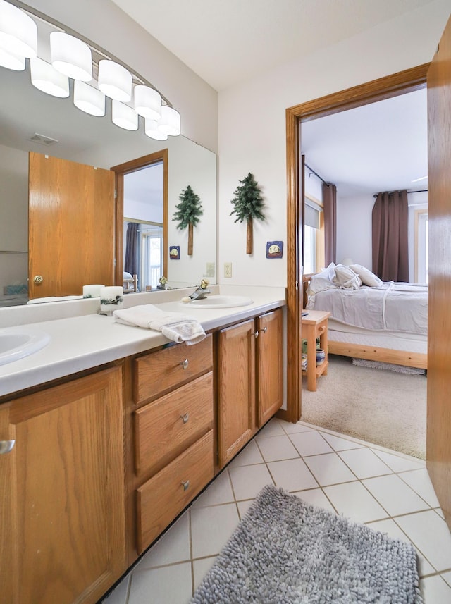 bathroom featuring visible vents, connected bathroom, tile patterned floors, vanity, and a wealth of natural light