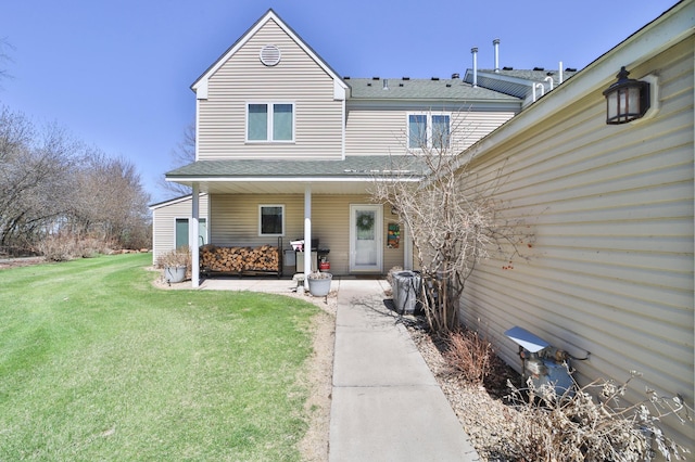 7968 Tournament Trl, Onamia, MN 56359 - view of front facade with a patio, a shingled roof, and a front yard