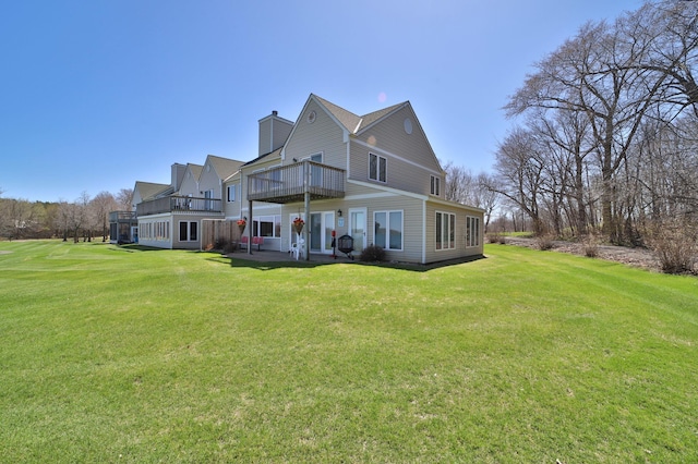 7968 Tournament Trl, Onamia, MN 56359 - back of house with a lawn, a wooden deck, a chimney, and a patio area