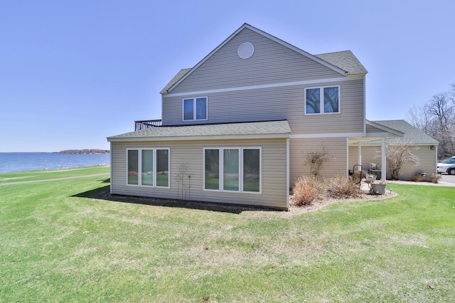 7968 Tournament Trl, Onamia, MN 56359 - rear view of house with a yard, a water view, and a shingled roof
