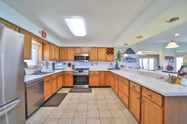 7968 Tournament Trl, Onamia, MN 56359 - kitchen with light countertops, a peninsula, appliances with stainless steel finishes, and a sink