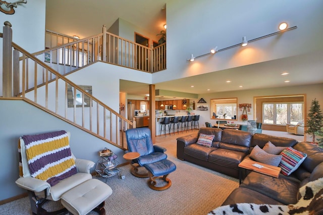 7968 Tournament Trl, Onamia, MN 56359 - carpeted living room featuring stairway, a high ceiling, and recessed lighting