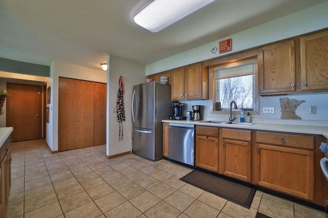 7968 Tournament Trl, Onamia, MN 56359 - kitchen featuring light countertops, brown cabinets, a sink, appliances with stainless steel finishes, and light tile patterned floors