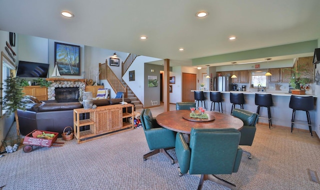 7968 Tournament Trl, Onamia, MN 56359 - dining area with stairway, light carpet, recessed lighting, and a stone fireplace