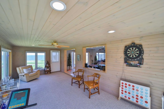 7968 Tournament Trl, Onamia, MN 56359 - living room with carpet flooring, ceiling fan, wood walls, and wooden ceiling