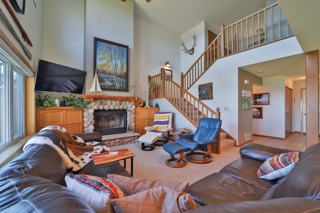 7968 Tournament Trl, Onamia, MN 56359 - living area with stairway, baseboards, a fireplace, and a towering ceiling