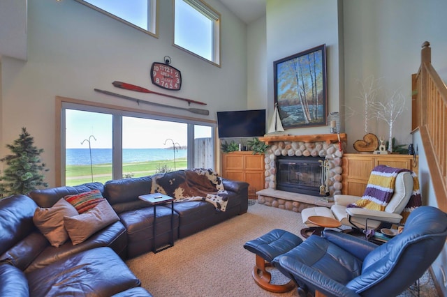 7968 Tournament Trl, Onamia, MN 56359 - carpeted living area featuring a stone fireplace and a towering ceiling