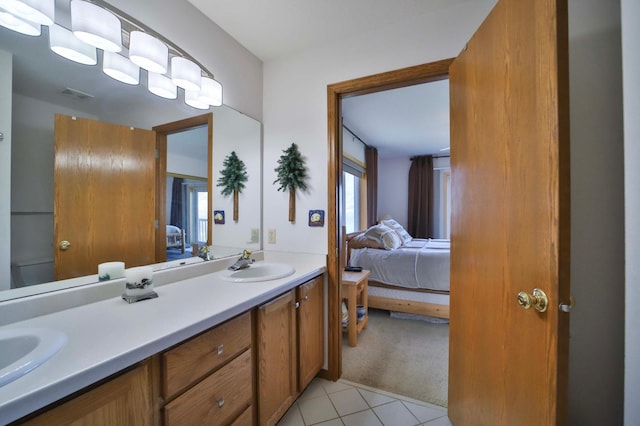 7968 Tournament Trl, Onamia, MN 56359 - ensuite bathroom with connected bathroom, a sink, double vanity, tile patterned floors, and visible vents