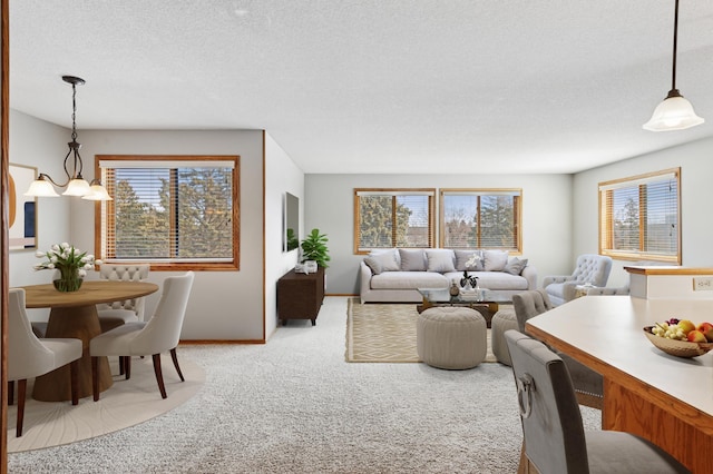 carpeted living room featuring a textured ceiling and baseboards