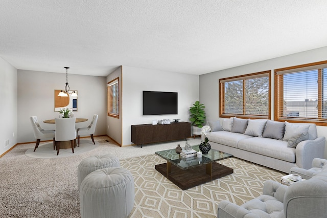 carpeted living area featuring baseboards and a textured ceiling