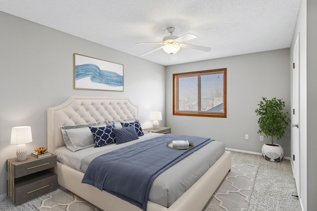 bedroom featuring a textured ceiling, a ceiling fan, baseboards, and carpet floors