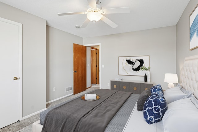 carpeted bedroom featuring visible vents, baseboards, and a ceiling fan