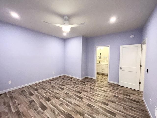 spare room featuring ceiling fan, wood finished floors, and baseboards