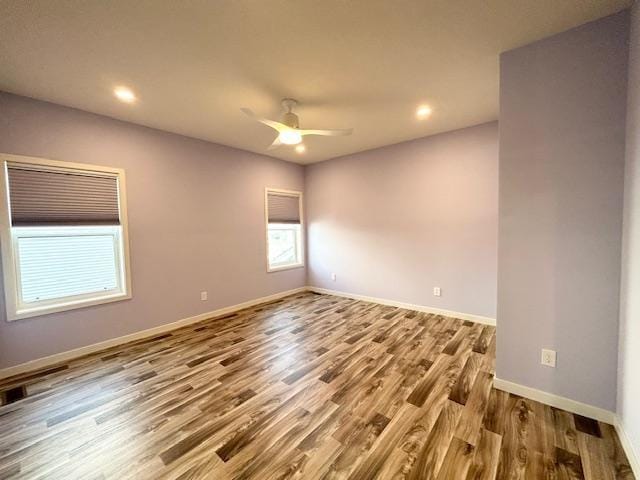 unfurnished room featuring ceiling fan, baseboards, wood finished floors, and recessed lighting