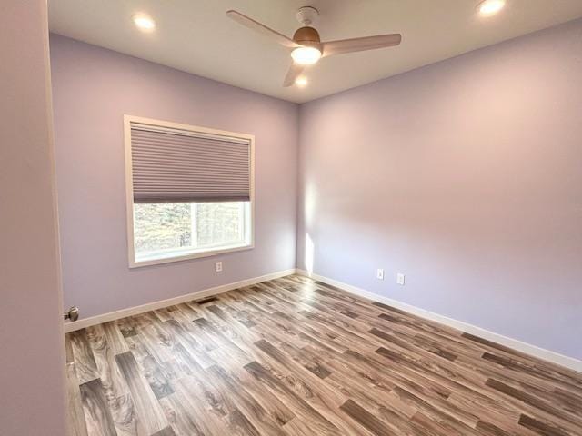 empty room featuring ceiling fan, baseboards, wood finished floors, and recessed lighting