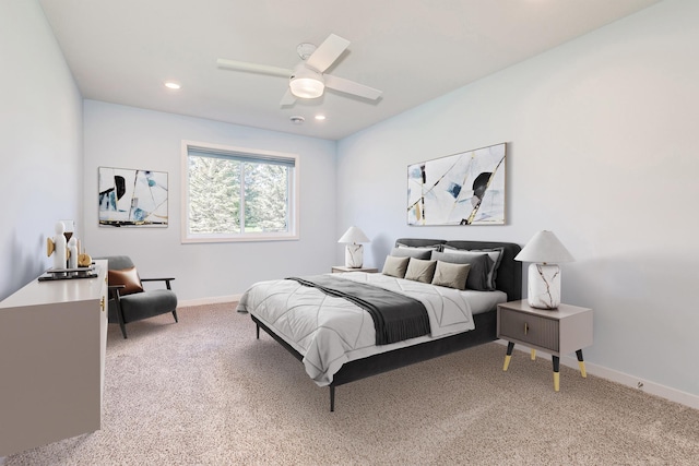 bedroom featuring recessed lighting, light colored carpet, ceiling fan, and baseboards