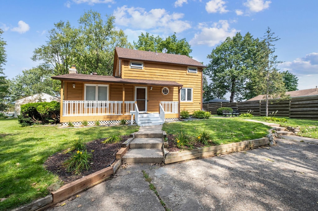 view of front of house featuring a front yard and a porch