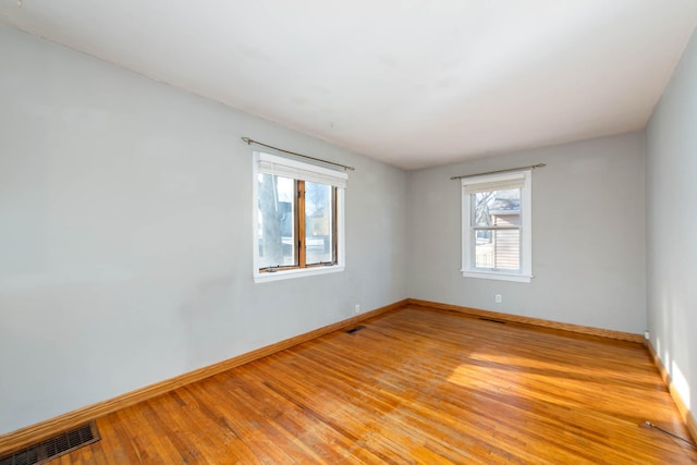 unfurnished room with light wood-type flooring