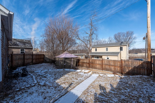 snowy yard with a gazebo