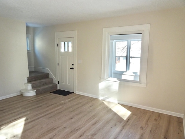 foyer entrance with light hardwood / wood-style floors