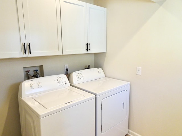 laundry area with cabinets and independent washer and dryer