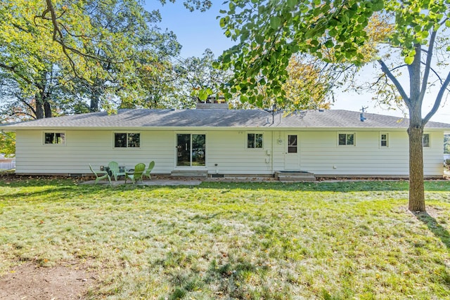 rear view of property featuring a yard