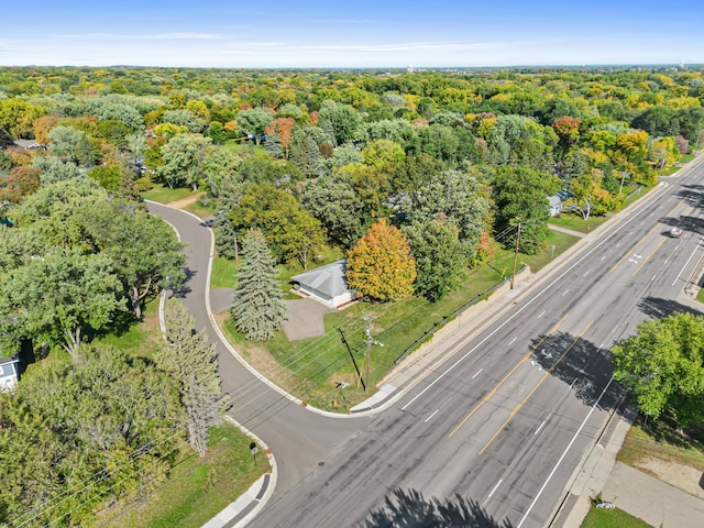 drone / aerial view featuring a forest view