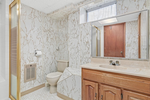 full bath with heating unit, wallpapered walls, toilet, vanity, and tile patterned floors