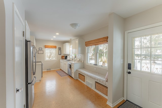 kitchen with white cabinetry, appliances with stainless steel finishes, and sink