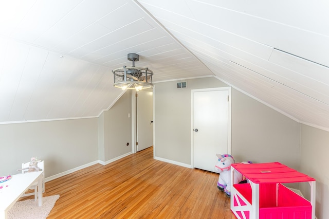 recreation room featuring hardwood / wood-style floors and lofted ceiling