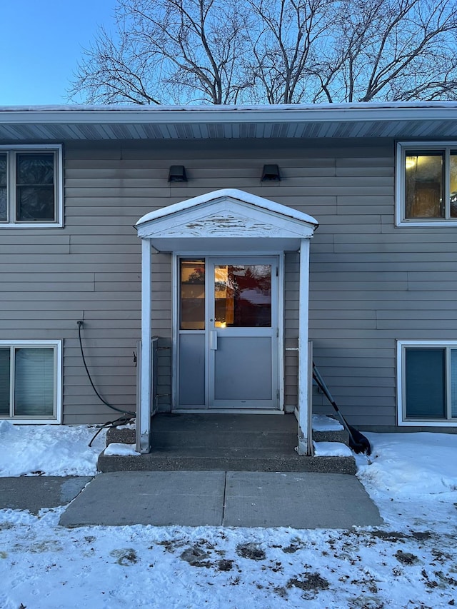 view of snow covered property entrance